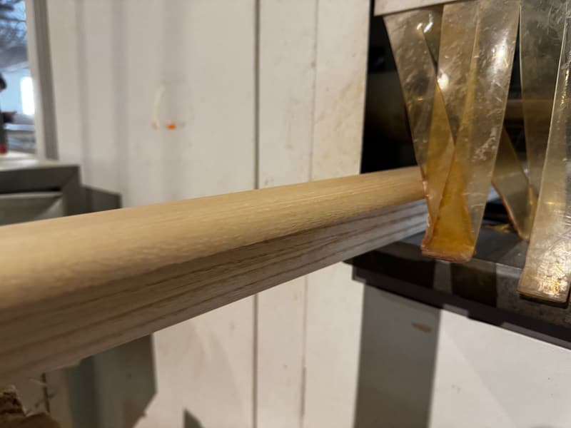 A timber louvre blank feeding into a profiling machine